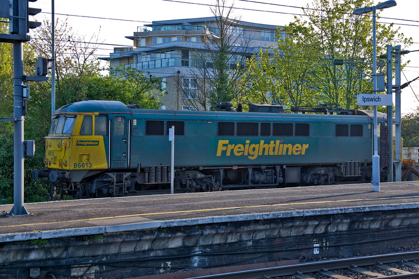 86613, stabled, Ipswich station 
 86613 looks a little forlorn left abandoned in the up side siding at Ipswich station. Not being familiar with the workings of the station I am not sure if it was simply stabled awaiting its next train or if it was in some sort of trouble and awaiting attention? 
 Keywords: 86613 stabled Ipswich station Freightliner AL6 AC electric