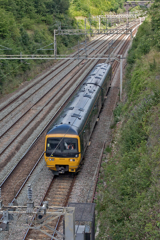 165134, 07.58 St. Philips Marsh-Wolverton Centre Sidings (7E), Hyde Road bridge 
 Whilst unit moves to and from Wolverton Works are a common event one arriving on a Sunday and one from Bristol arriving from the north is not so common! GWR's 165134 is seen passing Roade from Hyde Road bridge as the 07.58 St. Philips Marsh to Wolverton Centre Sidings move that, unfortunately, I do not have the reporting number for unless anybody can advise? This two-car unit took the unusual route via the GWML to Didcot and then north via Oxford and Banbury to Coventry where it reversed to run south as seen here on the WCML. 
 Keywords: 165134 07.58 St. Philips Marsh-Wolverton Centre Sidings 7E Hyde Road bridge GWR Great Western Railway