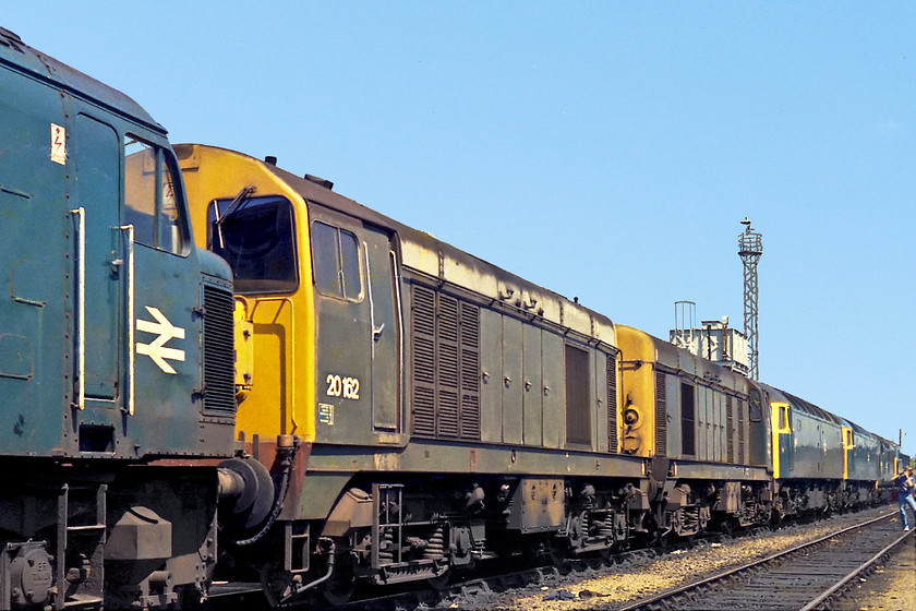 Class 45, 20162, 20001, 47486 & 47006, stabled, Severn Tunnel Junction MPD. 
 I was so excited to see some 20s at Severn Tunnel Junction and this made the visit worth while in itself! This was about as far as class 20s got into Western Region, they were that rare! Not only that, but both the ones seen here are still in their BR green livery. 20162 was a 1966 built 20 so it is likely that the green livery as seen here was its original one. It was withdrawn in 1987 and cut up at Vic Berry's infamous yard in Leicester. 20001 was the pioneer D8001 that was introduced way back in July 1957. At the time this picture was taken it was just 6 days off its 20th birthday! 20001 lives on and is preserved at The Midland Railway Centre. I wish I had the number of the split box 45 in the foreground!