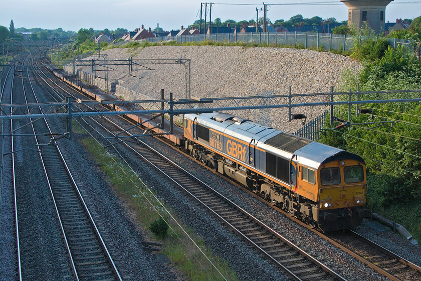 66763, 14.08 Garston-Dagenham Dock Reception (6L48, 12L), Ashton Road bridge 
 Approaching the longest day it is quite possible to take reasonable photographs fairly late into the evening. Even though 66763 'Severn Valley Railway' leading the 6L48 14.08 Garston to Dagenham Docks Siding is deep in a cutting just south of Roade the evening sun still catches the side of the train and creates some nice lighting. Taking photographs at this location from Ashton Road bridge is tricky and requires a ladder and one needs to keep one's wits about you as it is a reasonably busy single-track section of road! 
 Keywords: 66763 14.08 Garston-Dagenham Dock Reception 6L48 Ashton Road bridge GBRf Severn Valley Railway