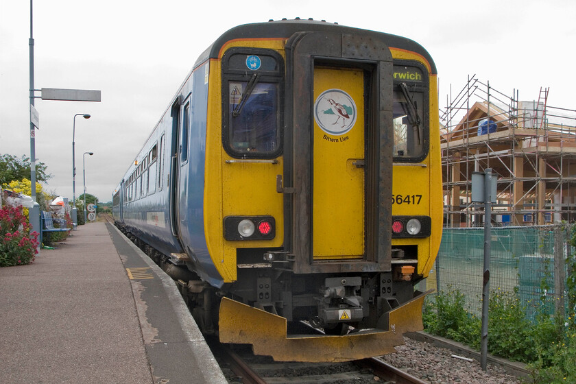 156417, 09.46 Sheringham-Norwich, Sheringham station 
 Proudly wearing its Bittern Line logo on the connecting door 156417 stands at Sheringham station waiting to work the 09.46 service to Norwich. Whilst the friends of Sheringham station keep it looking nice with a superb display of flowers, emptied waste bins and useful information the station is really too small and inadequate for the ever-increasing number of passengers who use it. Notice the new Tesco store taking shape in the background, something that has caused much controversy in this small and rather parochial North Norfolk town! 
 Keywords: 156417 09.46 Sheringham-Norwich Sheringham station