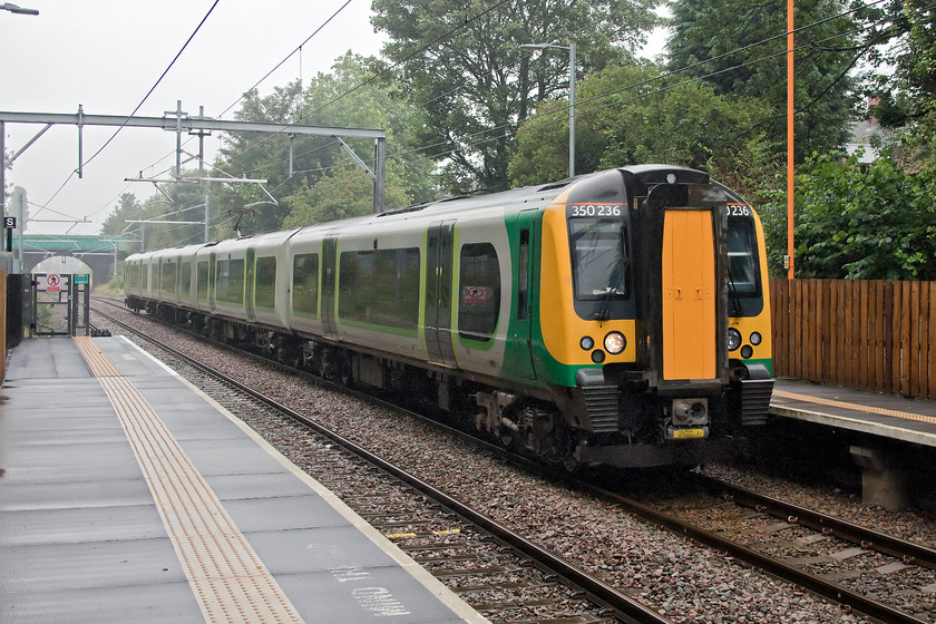 350236, LN 14.19 Rugely TV-London Euston (1Y58, 1E), Bloxwich station 
 The rain seems to have eased a little into a drizzle at Bloxwich station. 350236 arrives with the 14.19 Rugeley Trent Valley to Euston service, a train that will travel via Birmingham New Street where it will join another unit and reverse to continue its journey via the conventional route down the WCML. The wiring of the Chase Line, as it is referred to, was completed in April 2019 with the new service pattern commencing from the May timetable change. The intensity of services on this line, one that was seen as a bit of a backwater for many years, was a pleasant surprise. 
 Keywords: 350236 14.19 Rugely TV-London Euston 1Y58 Bloxwich station