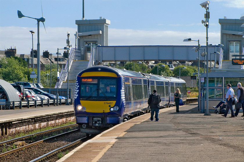 170457, SR 13.41 Glasgow Queen Street-Aberdeen (1A67), Montrose station 
 170457 arrives at Montrose station forming the 13.41 Glasgow Queen Street to Aberdeen ScotRail service. The new station footbridge and lifts dominate this scene that were opened in 2013. The station is a pretty soulless affair that on a balmy day such as this was acceptable but on a cold day in February offers little to the waiting passengers. 
 Keywords: 170457 13.41 Glasgow Queen Street-Aberdeen 1A67 Montrose station ScotRail