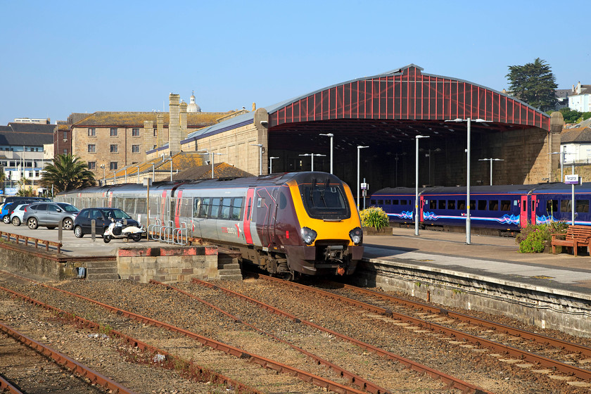 221134, XC 09.35 Penzance-Manchester Piccadilly (1M49, RT), Penzance station 
 221134 basks in the sun at Penzance station. It is going to work the 09.35 to Manchester Piccadilly. Not so long ago, this train would have been formed of a set of comfortable coaching stock with a locomotive up front. I am not sure that a class 221 is an improvement upon this, maybe cost wise for the TOC it works but, for the passenger? 
 Keywords: 221134 1M49 Penzance station