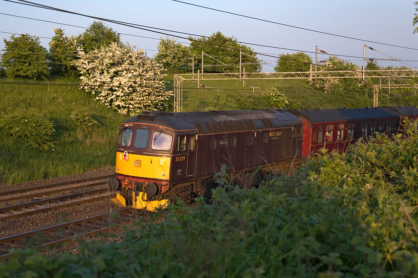 33029, on the up fast return leg of The Cheshireman, 17.07 Chester-London Euston (1Z73), Roade Hill 
 WCR's 33029 'Glen Loy' brings up the rear of The Cheshireman charter between Roade and Ashton with 60009 'Union of South Africa' leading at the front (see previoys photograph). Notice that the 1Z73 17.07 Chester to Euston is running on the up fast line rather than the customary slow. It was diverted on to this line at Hilmorton Junction to take the Weedon route due to an emergency closure of the slow lines at Long Buckby due to a failure. 
 Keywords: 33029 on the up fast return leg of The Cheshireman, 17.07 Chester-London Euston 1Z73 Roade Hill Glen Loy