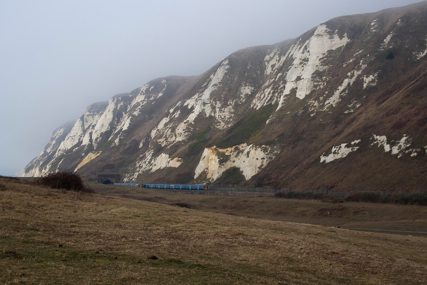 375304, SE 08.05 Ramsgate-London Charing Cross (2W26, RT) & class 375 SE 07.09 London Charing Cross-Dover (2R11, 1L), Samphire Hoe Country Park TR286388 
 With the haar clouding the top of the white cliffs the sun is attempting to break through at sea level. Two class 375s pass just outside of Abbotscliffe tunnel taken from Samphire Hoe country park. To the left is 375504 working the 08.05 Ramsgate to Charing Cross with another 375 to the right working the 07.09 Charing Cross to Dover. 
 Keywords: 375304 08.05 Ramsgate-London Charing Cross 2W26 class 375 07.09 London Charing Cross-Dover 2R11 Samphire Hoe Country Park TR286388