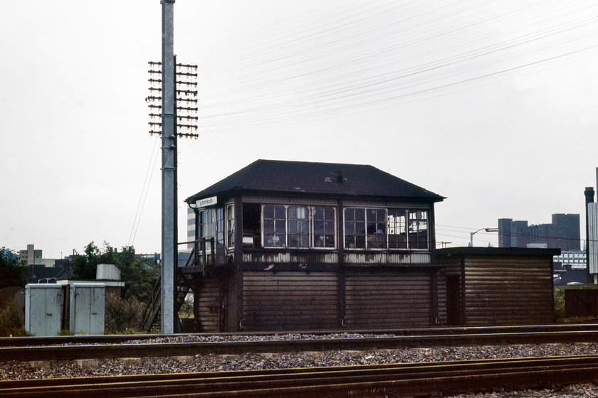 Luton South signal box (Midland, date not known) 
 Looking extremely dirty, Luton South signal box stands with a newly installed electrification mast just adjacent. I am not at all sure how I secured this photograph as I must have taken an expedition into the extensive yard where I am standing that today is a Network Rail compound. It was a Sunday morning so I suspect there were few people around to challenge me. but it would be something that I would or could not do today. 
 Keywords: Luton South signal box