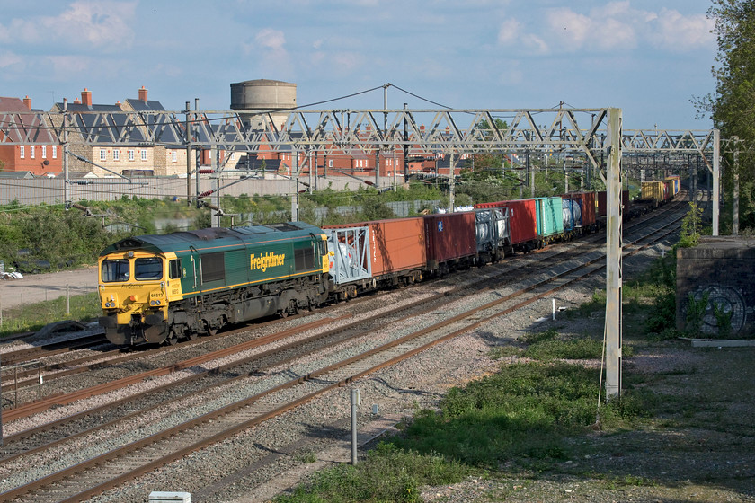 66513, 12.57 London Gateway-Garston (4M56, 36L), site of Roade station 
 In glorious afternoon sunshine and pleasantly warm for the beginning of May, 66513 rushes past the site of Roade's former station leading the 4M56 12.57 London Gateway to Garston. For the fifth day on the trot, the up and down fast lines, nearest to the camera, are out of use with the OLE de-energised enabling all sorts of maintenance to take place at various work sites between here at Roade and as far as Hilmorton Junction just south of Rugby. 
 Keywords: 66513 12.57 London Gateway-Garston 4M56 site of Roade station Freightliner