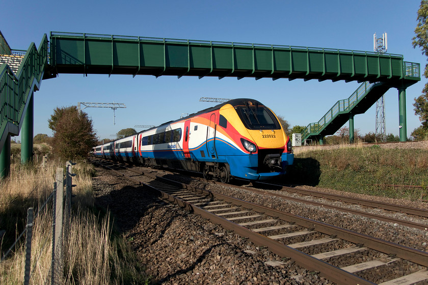 222022, EM 13.12 Nottingham-London St. Pancras (1B46, 29L), Irchester SP927667 
 222022 'Invest In Nottingham' passes under the new footbridge at Irchester working the late running 13.12 Nottingham to St. Pancras. I deliberately chose this ultra wide angle view to show the bridge and the beautiful autumnal blue sky. This bridge replaced a very rickety old structure a couple of years ago as part of the initial MML electrification works prior to it being 'paused' by the government. 
 Keywords: 222022 13.12 Nottingham-London St. Pancras 1B46 Irchester SP927667