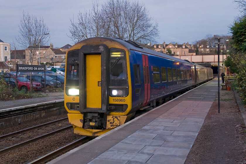 158960, GW 14.23 Portsmouth Harbour-Cardiff Central (1F24), Bradford-on-Avon station 
 The 14.23 Portsmouth Harbour to Cardiff Central service pauses at Bradford-on-Avon worked by FGW's 158960. This view shows some of Bradford's fine townhouses behind the train. Just out of view in the centre of the image is the house that I spent the first six years of my life in back in the 1960s. I now live over a hundred miles from here in the home counties but still feel a strange affinity when returning to what I could justifiably call 'home' I suppose! 
 Keywords: 158960 14.23 Portsmouth Harbour-Cardiff Central 1F24 Bradford-on-Avon station FGW First Great Western