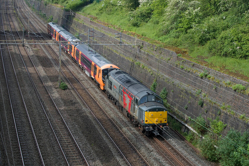 37884 & 730023, 10.25 Belmont Yard-Willesden (5Q72, 30E), Roade cutting 
 Europhoenix's 37884 'Cepheus' leads new build 730023 through Roade cutting as the 10.25 Belmont Yard to Willesden stock move. I presume, but am open to correction, that the Class 730 has been in store at Belmont Yard and that it is being moved south in readiness for its introduction to service with West Midlands Trains. 
 Keywords: 37884 730023 10.25 Belmont Yard-Willesden 5Q72 Roade cutting Cepheus Europhoenix Ltd