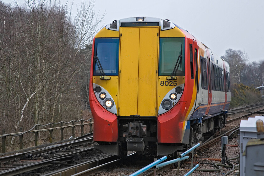 458025, SW 09.23 Ascot-Guildford, Ash Vale Junction 
 The odd front-end design of the Class 458/0 subset is clearly shown from this perspective. One of thrity members of the subset, 458025 crosses Ash Vale Junction working the 09.23 Ascot to Guildford service. All of these units are now in service but had a disastrous start back in the early 2000s beset with all sorts of problems and issues eventually leading to their complete withdrawal for major modifications. However, even now some ten years or so on they are still unreliable and face an uncertain future. 
 Keywords: 458025 09.23 Ascot-Guildford Ash Vale Junction SWT South West Trains Juniper