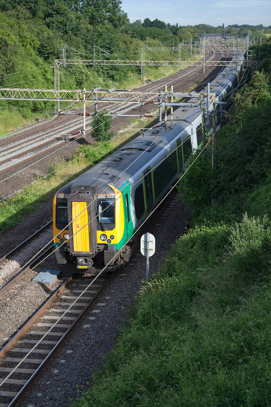 350122, 350258 & 350102, LN unidentified up working, Victoria Bridge 
 Due to the closure of the line north of Northampton because of an 'incident' no through trains were running through to Long Buckby and Rugby. However, London Northwestern were able to operate some trains starting from Northampton to Euston when a train crew and stock became available. No reporting number for this three-unit formation made up of 350122. 350258 and 350102 but it was packed with passengers so would have been heading for London here, passing Victoria Bridge near Roade. 
 Keywords: 350122 350258 350102 unidentified up working Victoria Bridge