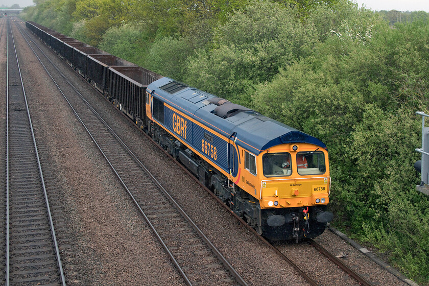 66758, 14.02 Scunthorpe Roxby Gullet-Collyhurst Street (6M59, 38L), Cuckoo bridge SE660116 
 Another example of a well kept GBRf Class 66 in the form of 66758 'The Pavior'. It is seen passing Cukoo bridge near Stainforth with the 6M59 Roxby Gullet to Collyhurst Street (Manchester) empties. On arrival in Manchester, the wagons are filled with waste that is then taken to Scunthorpe where it is used as landfill. Notice in this photograph that it has started to rain again and looking at the black clouds approaching behind it looks as though Andy and I were in for a soaking! 
 Keywords: 66758 14.02 Scunthorpe Roxby Gullet-Collyhurst Street 6M59 Cuckoo bridge SE660116 The Pavior