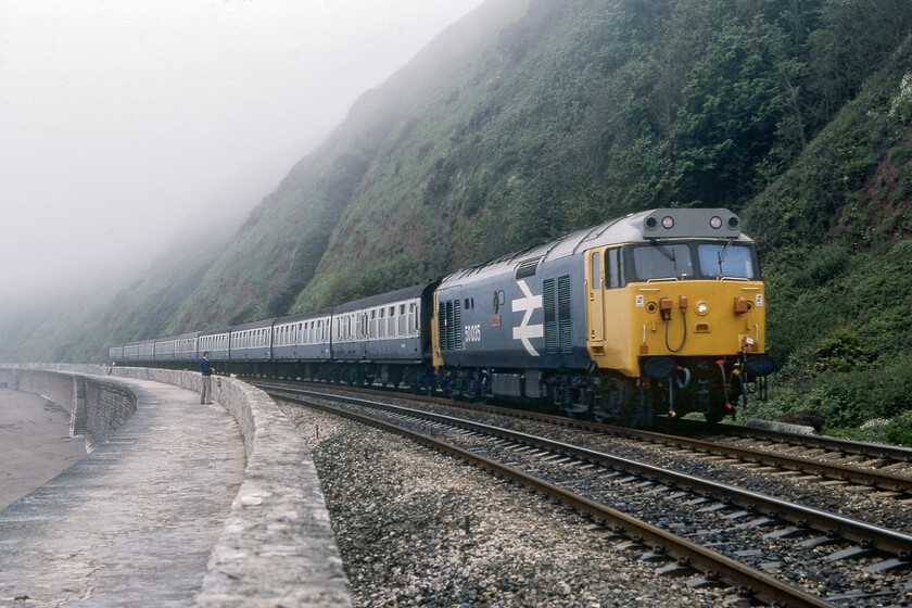 50035, 09.32 Penzance-Wolverhampton, Parson's tunnel 
 50035 'Ark Royal' only emerged from it's refurbishment and repaint into large logo livery six weeks or so prior to this photograph being taken and it still looks very smart! It is seen thundering along the South Devon sea wall on the approach to Parson's tunnel. leading the 09.32 Penzance to Wolverhampton service. This was an odd service terminating in the middle of the Black Country and I am not at all sure if the Class 50 hauled it all the way; advice anybody? 
 Keywords: 50035 09.32 Penzance-Wolverhampton Parson's tunnel Ark Royal