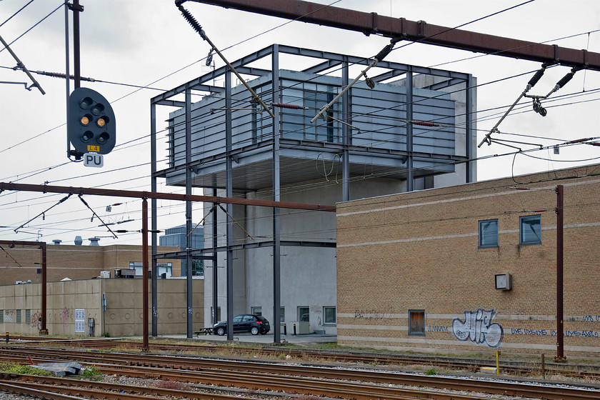 Roskilde signal box 
 I believe this to be Roskilde's signal box or control towers as they are referred to on the continent. It is certainly an unusual design dating I suspect from the 1980s or 1990s and is very 'Scandanavian' in its styling having a very de rigueur external steel frame! 
 Keywords: Roskilde signal box