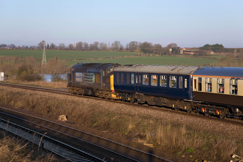 37194 outward leg of The Deviatoner, 06.22 Crewe-Ely Papworth Sidings (1Z20), Irchester Junction SP922673 
 Dead in tow 37194 brings up the rear of the outward leg of Pathfinder's The Deviatoner railtour as it comes off the fourteen arch Nene Valley viaduct between Wellingborough and Irchester. Unfortunately, 37194 was to disgrace itself later in the day with a burst coolant pipe necessitating some changes to the schedule. 
 Keywords: 37194 The Deviatoner 06.22 Crewe-Ely Papworth Sidings1Z20 Irchester Junction SP922673 Pathfinder Tours