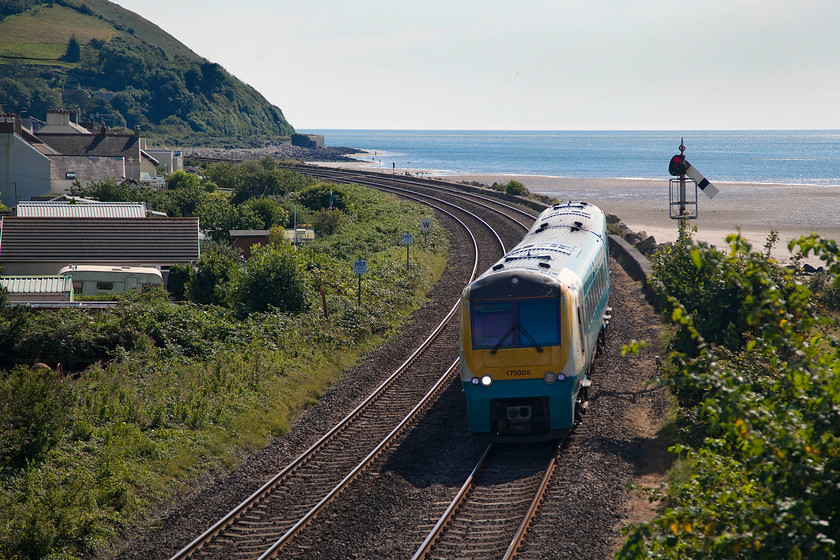 175005, AW 10.30 Manchester Piccadilly-Milford Haven (1V39), Ferryside station 
 The section of line that runs along the Gwendraeth and Towy estuaries is an equal for the south Devon coast line. The line hugs the coast from where it leaves Kidwelly all the way to Carmarthen offering delightful views to the passengers. Unfortunately, for the railway photographer, there are limited opportunities to take pictures due to difficult access so I believe that this is the reason that there is such a dearth of images. This picture shows 175005 approaching Ferryside station passing its down home signal forming the 10.30 Manchester Piccadilly to Milford Haven. Notice the HST stop boards on the up line. The tiny station enjoys a direct HST service to and from Paddington twice a day. 
 Keywords: 175005 10.30 Manchester Piccadilly-Milford Haven 1V39 Ferryside station