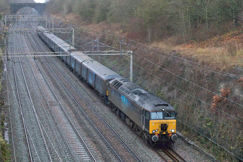 57312, 768001 & 319373, 05.34 Shieldmuir-Willesden PRDC (3Q41, 9L), Hyde Road bridge 
 With the staff training and test runs over Orion Logistics have started operating services on the WCML. However, I am not at all sure how much freight is actually being carried but it is good to see at least some coming off the roads as a result of new flows on the railways. I was under the impression that the former Thameslink units that have been prepared for Orion at Long Marston were to be running under their own AC power all the way but it appears that this is not the case with veteran Class 47 now running as 57212 hauling the train. The 05.35 Sheildnuir to Willesden Park Royal is seen passing through Roade from the village's Hyde Road bridge with 768001 and 319373 making up the stock. 
 Keywords: 57312 768001 319373 05.34 Shieldmuir-Willesden PRDC 3Q41 Hyde Road bridge Orion logistics