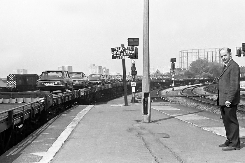 Up Motorail working, Bristol TM station 
 But for the station pilot class 08 there is no locomotive in this picture but it's full of historical interest none-the-less. An up Motorail is seen running non-stop through Bristol Temple Meads, this itself was rare for a passenger working. It will have originated from one of St. Austell, Newton Abbot or even Taunton. A closer look at the scanned image reveals an interesting array of vehicles on the uncovered open flats. I cannot make out a single foreign interloper almost the Triumphs, Fords, Morris', Vauxhalls and Hillmans. The green Triumph at the back is a 1500 variant that looks very similar to my parents Dolomite that they owned at this time. The vehicle seen, MJC 682L was last on the road in summer 1988 so still had eleven years of motoring left in it from when this picture was taken. I have no idea who the fella watching me take the picture was, if he was a spotter then he does seem a little over-dressed for it!