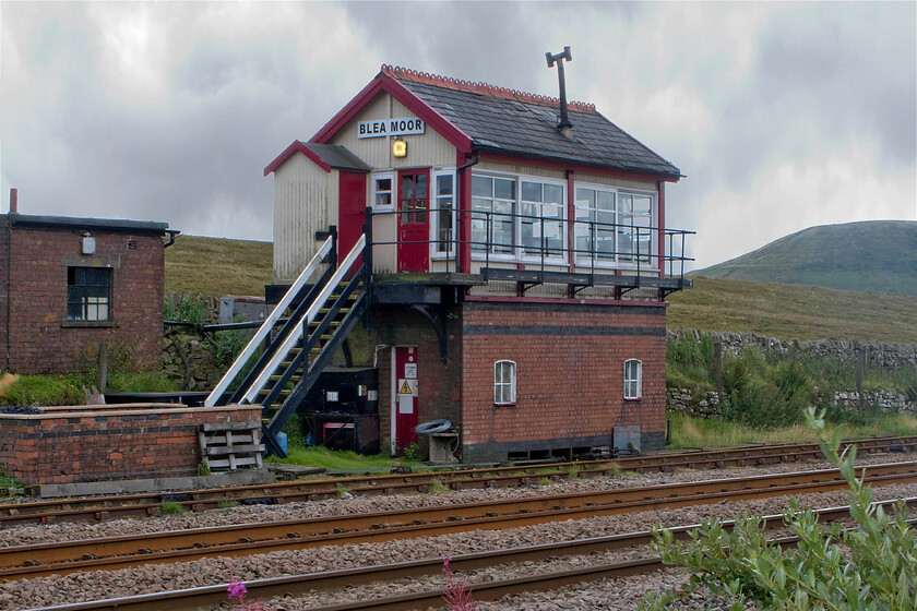 Blea Moor signal box (LMS, 1941) 
 Even on a benign but cloudy August day Blea Moor signal box is a pretty isolated place to be high up on the fells at one thousand one hundred feet and in the shadow of the bulk of Whernside over which traverses the Pennine Way long distance footpath. However, on a stormy night in December, it must be a heck of a place to work; it's no wonder that the stove pipe is at a jaunty angle! 
 Keywords: Blea Moor signal box LMS