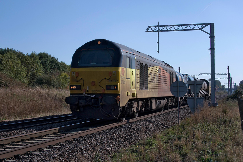 67027 & 67023, 11.53 West Hampstead North Junction-Toton RHTT (3J93), Irchester SP927667 
 A rail head treatment train, not in action, passes Irchester just south of Wellingborough. It is being hauled by Colas 67027 'Charlotte' with 67023 'Stella' on the rear and forms the 3J93 West Hampstead to Toton. Notice the recent arrival of the electrification masts at the previously open spot. 
 Keywords: 67027 67023 11.53 West Hampstead North Junction-Toton RHTT 3J93 Irchester SP927667