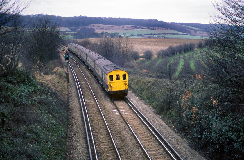 1002, unidentified London Charing Cross-Hastings working (22), Otford TQ514584-30.01.80 
 Just west of the village of Otford the Pilgrims' Way crosses the London to Hastings line. As my patrol was crossing the bridge I heard the unmistakable sound of a Thumper approaching from the London direction having just emerged from Polehill tunnel. With the escarpment of the North Downs in the background DEMU 'Slim Jim' 1004 heads south with an unidentified Charing Cross to Hastings service via Orpington and Battle service. Close examination reveals some oast houses at the foot of the escarpment with their associated hop plantations to the immediate right. 
 Keywords: 1002 London Charing Cross-Hastings via Orpington & Battle working 22 Otford TQ514584