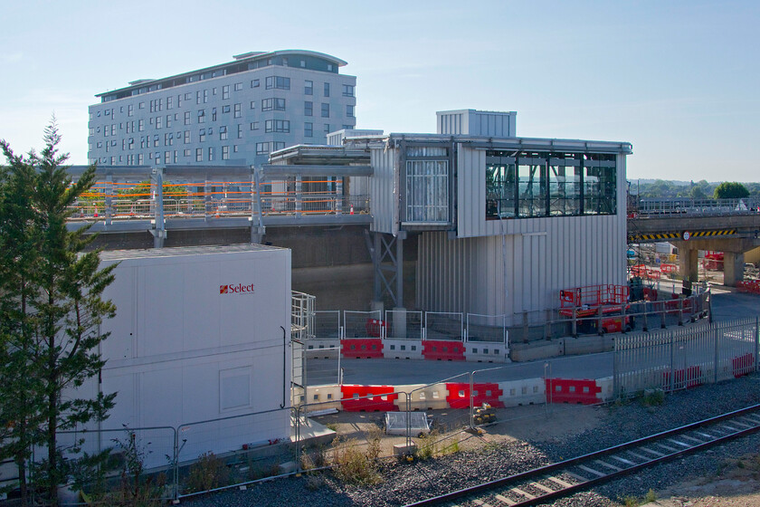 EWR station extension, Bletchley station 
 Tangible progress is being made on East West Rail's project to connect Oxford to Bedford via Bicester (completed) and Bletchley. The new station extension is seen elevated on the rebuilt eastern side of the famous concrete flyover. The rectangular section directly in the centre of the photograph will be where the existing footbridge on which I am standing will be extended and enter the new part of the station. One wonders what the station extension will be called, will it still just be Bletchley or perhaps Bletchley EWR? 
 Keywords: EWR station extension Bletchley station