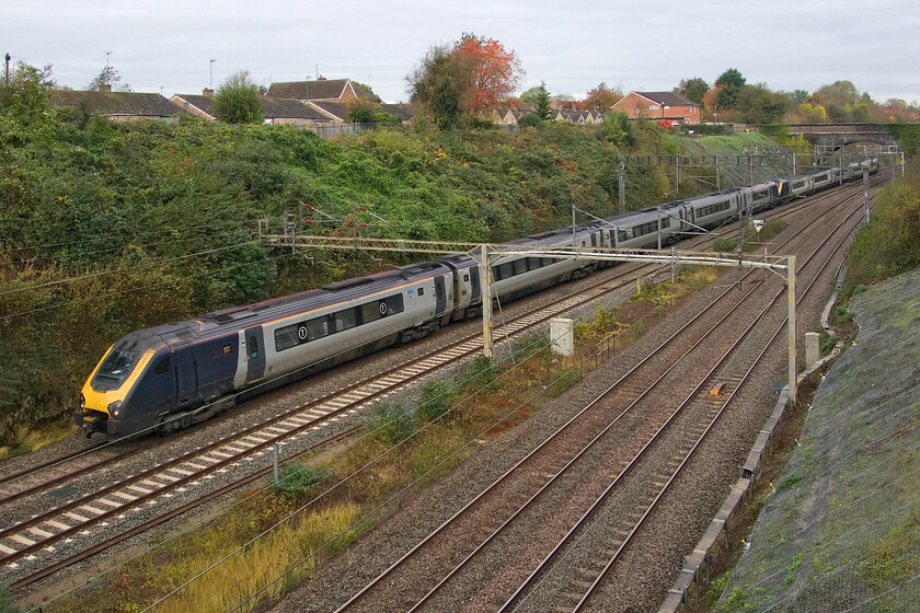 221101 & 221103, VT 09.02 London Euston-Holyhead (1D83, 1E), A508 bridge 
 I was not expecting a pair of Voyagers to pass whilst I was standing on Roade's former A508 road bridge. The 1D83 09.02 Euston to Holyhead Avanti service should have been a Class 805, indeed RTT was showing this to be the case, but obviously, something was amiss hence it being worked by 221101 and 221103 now devoid of any Avanti graphics. After a few days of lovely autumn sunshine, today is particularly dull and grey and all this marking the end of British Summer Time with the clocks going back this evening; bring on 30.03.25! 
 Keywords: 221101 221103 09.02 London Euston-Holyhead 1D83 A508 bridge AWC Avanti West Coast Voyager