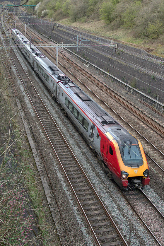 Class 221, VT 14.35 Chester-London Euston (1A45, RT), Roade cutting 
 An Avanti West Coast Voyager passes through Roade cutting forming the 14.35 Chester to London. I am pleased to report that during the emergency timetable the only Voyager workings appear to be those that go away from the wires for part of their journey with all other services being handled by Pendolinos. Of course, all the trains are running virtually empty as the travel restrictions continue in an effort to control the spread of the Covid-19 pandemic. 
 Keywords: Class 221 14.35 Chester-London Euston 1A45 Roade cutting Avanti West Coast Voyager