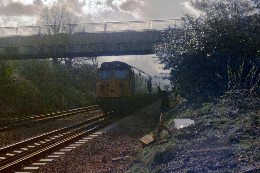 Class 50, unidentified up working, Bathampton Junction 
 My friend, Simon Petrameredies, gives a thumbs up to the driver of the unidentified Class 50 heading an up express for London Paddington. He's doing this in order to extract a blast on the horn because in the plastic bag was my cassette recorder attempting to capture the sound on some grotty C.60 cassette! I suspect that the driver would have given a blast on the horn without the gesture given our position on the lineside. We are actually standing on the rubble that was formally the up platform at Bathampton that was closed on 03.10.66, only eleven years prior to when this picture was taken! 
 Keywords: Class 50 Hoover Bathampton Junction Bath