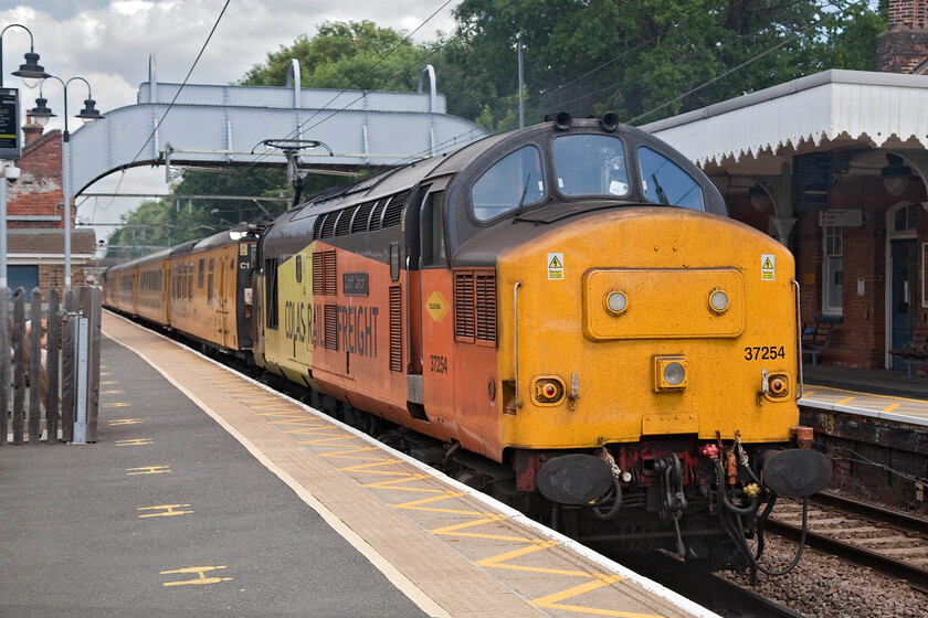 37254, 10.14 Welwyn Garden City-Cambridge Reception Sidings (1Q18, 4E), Ingatestone station 
 37254 'Cardiff Canton' provides the power at the rear of the 10.14 Welwyn Garden City to Cambridge Network Rail test train. The train is seen passing through Ingatestone station on the GEML in Essex. Andy is just visible partially obscured by the fencing in this photograph recording his own image. 
 Keywords: 37254 10.14 Welwyn Garden City-Cambridge Reception Sidings 1Q18 Ingatestone station Cardiff Canton Colas Rail Freight