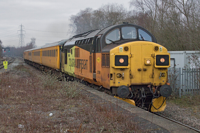 37099, 06.44 Cardiff Central-Derby RTC (1Z59, 16E), Water Orton station 
 It always gladdens the heart when something interesting appears and makes it worthwhile to turn out to the lineside on such a cold and miserable morning! With a toot from the enthusiastic driver 37099 'Merl Evans 1947-2016' passes through Water Orton station leading the 06.44 Cardiff Central to Derby RTC 1Z50 test train. The train left Cardiff on schedule but steadily gained time on its journey from South Wales arriving at Derby just over a quarter of an hour ahead of time with the driver no doubt pleased to get his breakfast in the mess room! 
 Keywords: 37099 06.44 Cardiff Central-Derby RTC 1Z59 Water Orton station Merl Evans 1947-2016