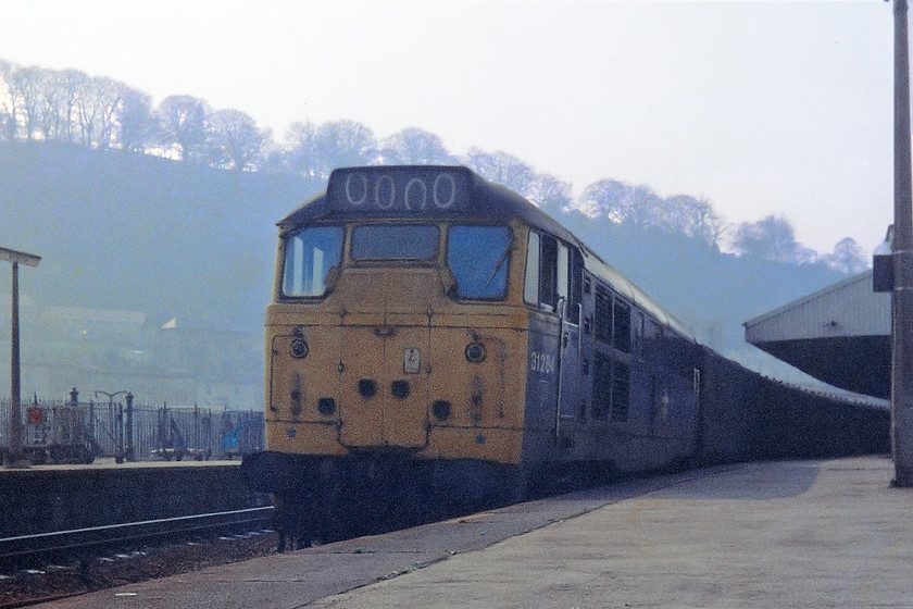 31284, up parcels, Bath Spa station 
 31284 gets an up parcels working underway out of Bath Spa station. 31284 was introduced in September 1961 eventually being withdrawn in August 1989 and cut-up at MC Metals in Glasgow. This was one of my 'low-angle' shots that I had a propensity to take at this time. In this spot, looking in this direction at this time of day it was about the worst choice of angle as it was looking bang into the afternoon light! Oh. well, I was young and nave about such things then! 
 Keywords: 31284 Bath Spa station parcels working train