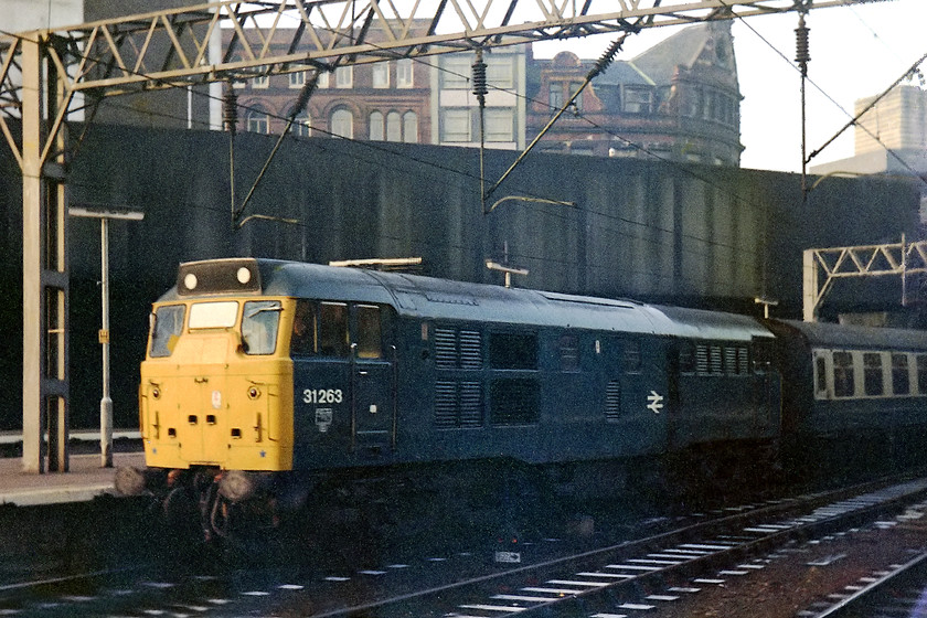 31263, unidentified working, Birmingham New Street station 
 31263 arrives into Birmingham New Street station. As a March locomotive this particular 31 did a lot of its work in the Eastern Region. Looking at its logs it powered many of the Norwich-Birmingham-Norwich workings and I suspect that this will have been what it was doing on this particular day. A comfy and properly sprung seat in a Mk1. coach has to be better than the plastic 172 units (or whatever else runs on this route) now! 
 Keywords: 31263 Birmingham New Street