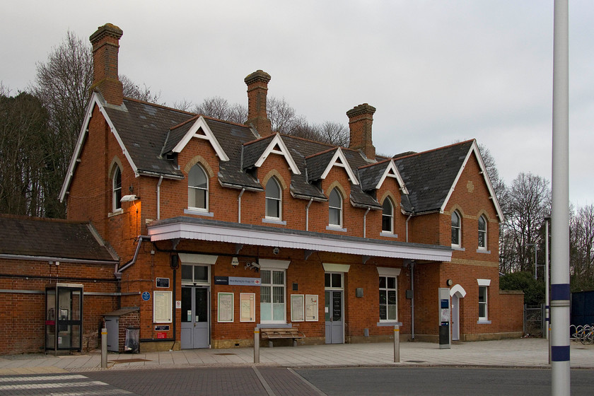 Frontage, West Malling for Kings Hill station 
 The impressive station at West Malling in the gathering dusk. The station had just been in receipt of some investment with a huge new car park having just been opened and new lighting. There was also a new sheltered bus stop and taxi rank to assist the many commuters that obviously use the station during the week. Notice the blue plaque on the front of the building. This commemorated that the author George Orwell spent some time living in a nearby sanatorium writing a number of his novels. 
 Keywords: West Malling for Kings Hill station