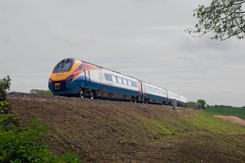 222103, EM 10.29 London St. Pancras-Nottingham (1D24, 1E), Sharnbrook SP987608 
 A huge amount of line-side clearance has taken place around Sharnbrook and new drainage channels installed. The clearance has created some new photographic opportunities such as this one. Here, 222103, formally named 'Dr John Godber' when it was Hull Trains, passes Sharnbrook with the 10.29 St. Pancras to Nottingham. 
 Keywords: 222103 1D24 Sharnbrook SP987608