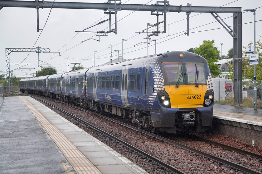 334022, SR 07.24 Milngavie-Edinburgh Waverley (2M20, 1E), Bathgate station 
 In the pouring rain, 334022 arrives at Bathgate station with the 2M20 Milngavie to Edinburgh Waverley service. Bathgate station was a completely modern structure that was pretty soulless, even more so on such a miserable and wet Saturday morning! 
 Keywords: 334022 07.24 Milngavie-Edinburgh Waverley 2M20 Bathgate station