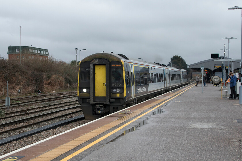 159006, SW 10.38 Basingstoke-Yeovil Junction (1V23, 1L), Westbury station 
 Whilst Westbury is seemingly deep in GWR territory South Western Railway make some inroads. Using the Wiltshire town as a reversal point the 1V23 10.38 Basinsoke to Yeovil Junction takes a circuitous route via Salisbury, Warminster and then onwards from here to Frome and Castle Cary. With the driver having changed ends, 159006 leaves Westbury largely being ignored by the regular spotters and photographers on the platform. 
 Keywords: 159006 10.38 Basingstoke-Yeovil Junction 1V23 Westbury station SWR South Western Railway