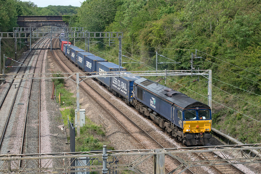 66423, 13.09 DIRFT-Purfleet (4L48, 36L), A508 road bridge 
 Yet another picture of 66423 leading the 4L48 DIRFT to Purfleet Tesco working. I took a virtually identical photograph in January last year. See..... https://www.ontheupfast.com/p/21936chg/25757907804/x66423-13-09-dirft-purfleet-4l48 but the weather was a little different then! 
 Keywords: 66423 13.09 DIRFT-Purfleet 4L48 A508 road bridge DRS Direct Rail Services