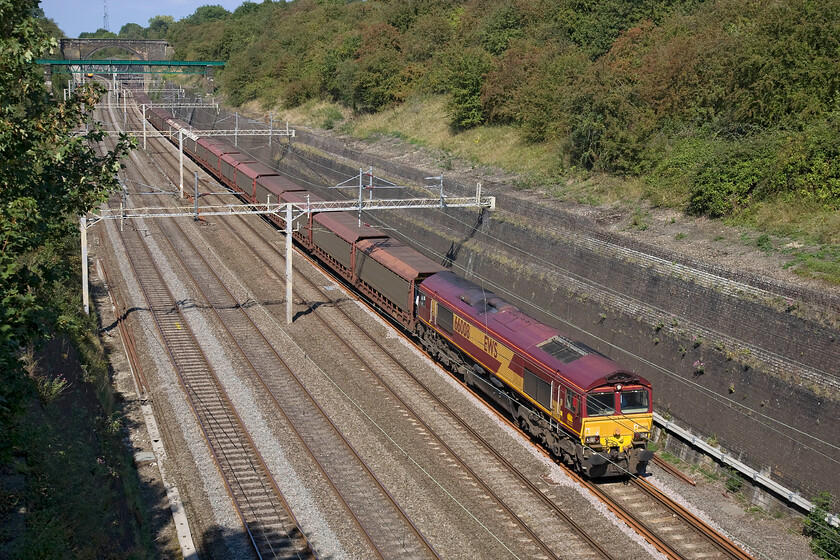 66008, 09.15 Halewood-Southampton Eastern Docks (6O38), Roade cutting 
 66008 leads the 09.15 Halewood to Southampton Docks loaded cartic train through Rode cutting. This 6O38 train would usually travel via Banbury, Oxford and Reading but due to engineering works it was diverted up the WCML. Notice the very subtle changes to the vegetation lining the top of the cutting as we have just entered September the warm mellowness of autumn is just starting to show its hand. 
 Keywords: 66008 09.15 Halewood-Southampton Eastern Docks 6O38 Roade cutting EWS