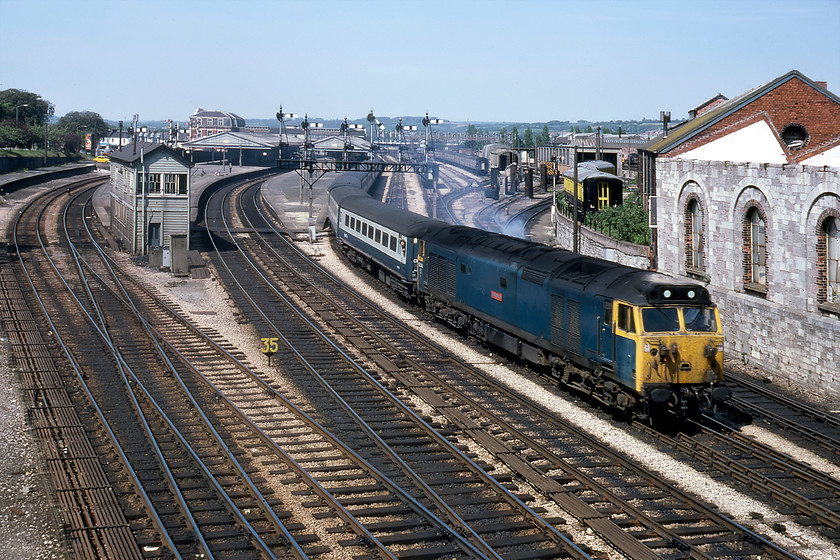 50040, 11.30 London Paddington-Paignton, Torquay Road bridge, Newton Abbot 
 This was a photograph that I managed by the skin of my teeth! We had travelled behind a work-weary 50040 'Leviathan' leading the 11.30 Paddington to Penzance from Exeter as far as here at Newton Abbott. I then managed to run, after alighting from the train, to this location on Torquay Road to take the train leaving the station from this classic location. My companion did not manage to make it, but I did have a few years on him, being a sprightly sixteen year old! The scene is full of interest apart from the train of course. The David and Charles publishing company buildings are to the right, complete with a rake of coaches painted in the D&C corporate colours. The signalling is absolutely superb with Newton Abbot West signal box to the left and just look at the number of rods used to control the point work. Today, whilst the scene is similar, there has been a vast reduction in infrastructure with just three running lines.

There is an audio recording taken a little earlier of this train leaving Exeter St. David's on my youtube channel, see....https://youtu.be/dwgFfxAXopw 
 Keywords: 50040 11.30 London Paddington-Paignton Torquay Road bridge Newton Abbot Leviathan Warship