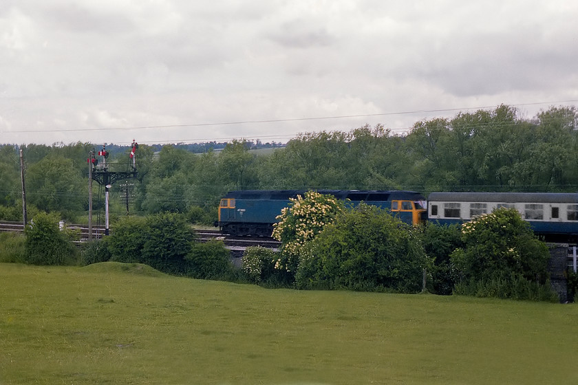 47080, unidentified down working, Hungerford SU345682 
 Bristol Bath Road based 47080 'Titan' approaches Hungerford passing the Common to the east of the town. It is leading a set of Mk. I stock heading westwards with an unidentified down working. In its 34 year life, this loco. carried a total of five numbers, D1665, 47080, 47612, 47838 and 47779 but was named 'Titan' throughout. 
 Keywords: 47080 down working Hungerford SU345682