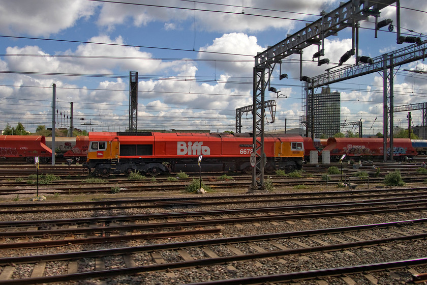 66783, stabled, Wembley yard 
 66783 'The Flying Dustman' sits stabled in Wembley yard. As a reasonably early delivery, this class 66 carried the number 66058 that I have a number of pictures of wearing its EWS livery. In the spring of 2018 it was selected by its new operator, GB Railfreight, to be the lucky recipient of this bright paint scheme and branding to commemorate GB Railfreight's partnership with the waste services company Biffa. It was named at York station on 28.03.18. 
 Keywords: 66783 Wembley yard