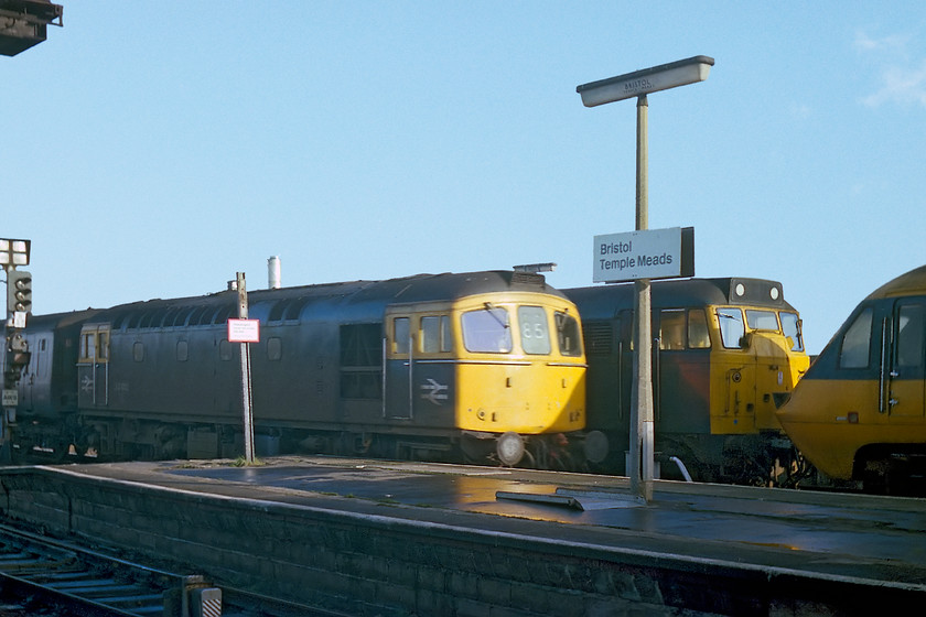 33012, 10.42 Portsmouth Harbour-Bristol Temple Meads & 31121 & 253009, Bristol Temple Meads station 
 Taken the wrong side of the sun but an interesting picture nonetheless. 33012 arrives at Bristol Temple Meads leading the 10.42 from Portsmouth Harbour that will terminate here. Once again I am grateful to Kevin Daniel, with his wealth of contemporary HST data, who reliably informs me that 31121 is towing HST set 253005. He says that this set was brought in from St. Philips Marsh depot and was scheduled to leave Temple Meads for a visit to Derby Works (as a Q working) due off at 13.26. This is about the same time as the Portsmouth train was due in at 13.17 so all this would appear to tie in, I have now updated my notes; thanks Kevin! Incidentally, 33012 lives on today as a member of the UK's heritage fleet now repainted green carrying the name 'Lt Jenny Lewis RN' numbered and D6515, see..... https://www.ontheupfast.com/p/21936chg/30054715722/d6515-73109-4tc-69002-return-jurassic 
 Keywords: 33012 10.42 Portsmouth Harbour-Bristol Temple Meads 31121 253009 Bristol Temple Meds station