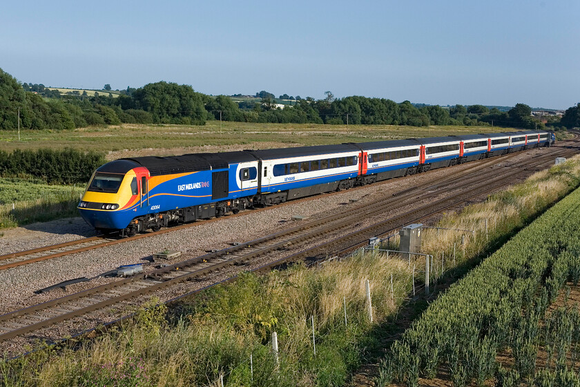 43064, EM 17.45 London St. Pancras-Derby, Harrowden Junction 
 On the slow line, power car 43064 leads the 17.45 St. Pancras to Derby EMT service past Harrowden Junction between Wellingborough and Kettering. This power car first saw service on the Eastern Region in 1977 being part of set 254005 challenging the Deltics' supremacy at that time! 
 Keywords: 43064 EM 17.45 London St. Pancras-Derby Harrowden Junction