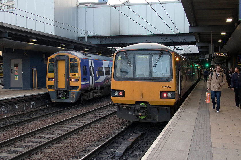 158903, NT 17.36 Leeds-Manchester Victoria (1D95, 12L) & 144007, NT 17.29 Leeds-Knottingley (2A25, 4L), Leeds station 
 According to Leeds' station clock, 158903's departure is imminent as the 17.36 to Manchester Victoria. However, 144007 is now a little late with the 17.29 to Knottingley. 
 Keywords: 158903 17.36 Leeds-Manchester Victoria 1D95 144007 17.29 Leeds-Knottingley 2A25 Leeds station