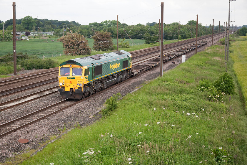 66544, 11.45 Carlisle North Yard-York Yard South, Otterington SE380879 
 A light load for 66544 as it trundles along the up slow of the ECML past Otterington between Thirsk and Northallerton. This working, that is composed of Freightliner flats going for repair or maintenance, is the 11.45 Carlisle North Yard to York Yard South. 
 Keywords: 66544 11.45 Carlisle North Yard-York Yard South Otterington SE380879