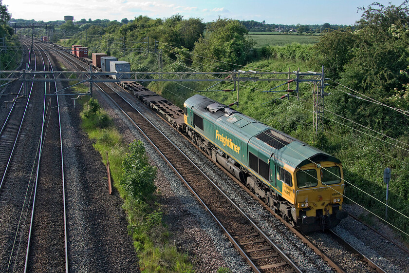 66518, 13.34 Ditton-Felixstowe North (4L92, 10E), Victoria bridge 
 66518 passes Victoria bridge just south of Roade leading the 13.34 Ditton to Felixstowe Freightliner service. After some heavily loaded trains passing in the last few months or so the 4L92 bucks the trend with a dearth of boxes in evidence behind the locomotive. 
 Keywords: 66518 13.34 Ditton-Felixstowe North 4L92 Victoria bridge Freightliner