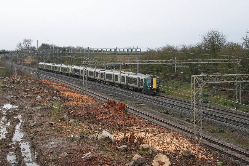 350232, LN 07.46 London Euston-Crewe (1U25, 4L), Ashton Road bridge 
 With the embankment rather brutally stripped of all vegetation following recent clearance by Network Rail's contractors 350232 is clearly seen working the 07.46 Euston to Crewe on the down fast line. This spot is just south of Roade and the purpose of the clearance is to undertake embankment repairs and stabilisation. 
 Keywords: 350232 07.46 London Euston-Crewe 1U25 Ashton Road bridge